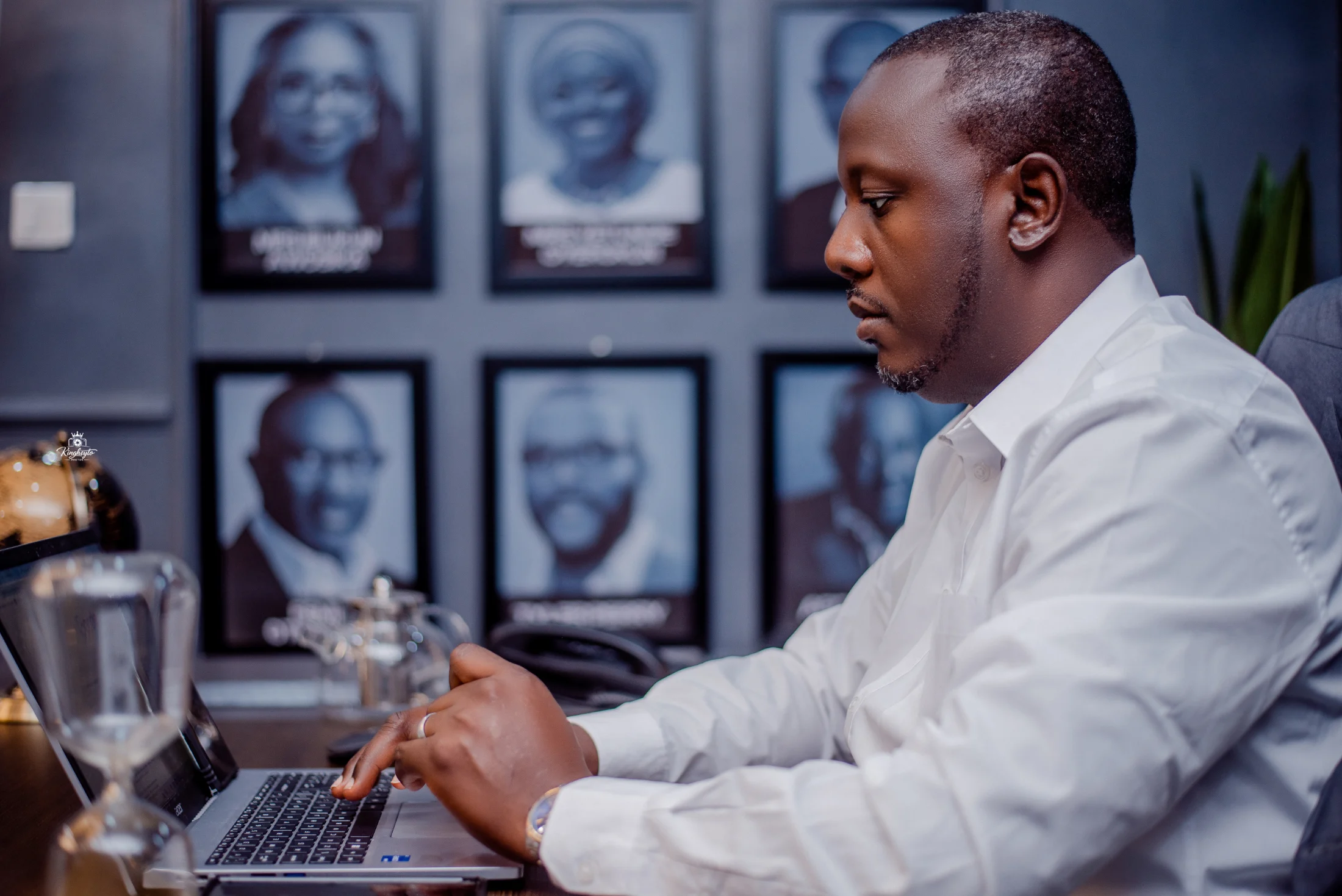 Engr. Omotayo Oyerokun reviewing work on a laptop in his office